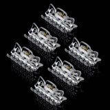 Six essential hair claw clips with yellow eyes on black background