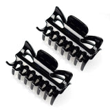 Two black plastic bottle openers on white background