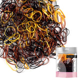 Extra strong mini rubber bands in a pile with bag of hair ties