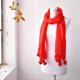 Red faux fur pom pom pashmina winter scarf on man.