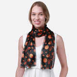 Woman wearing Halloween Pumpkin Silky Satin Striped Scarf with orange pumpkins
