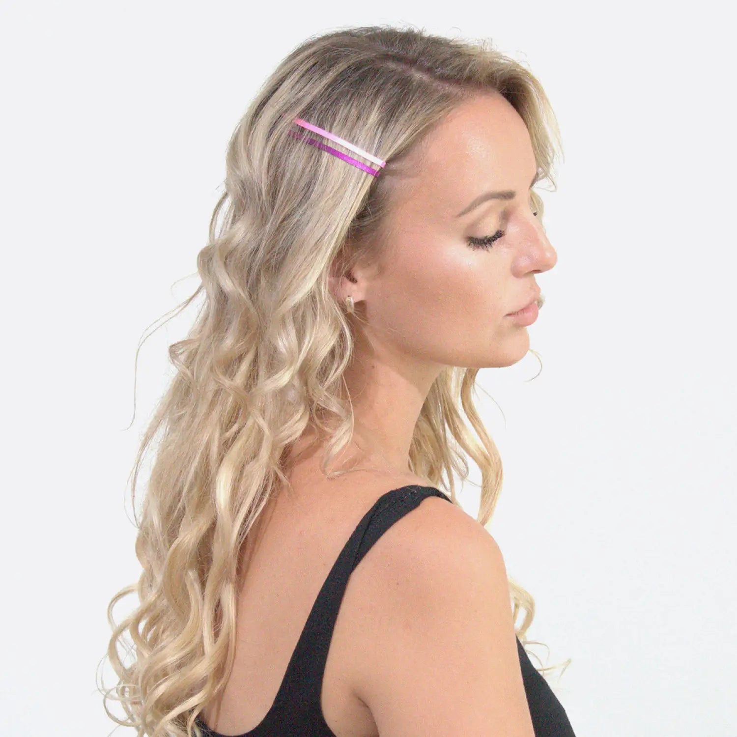 Blonde woman with pink hair clip showcasing Jumbo Metal Bobby Pins - Large Set.
