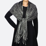 Metallic aztec print scarf worn by woman