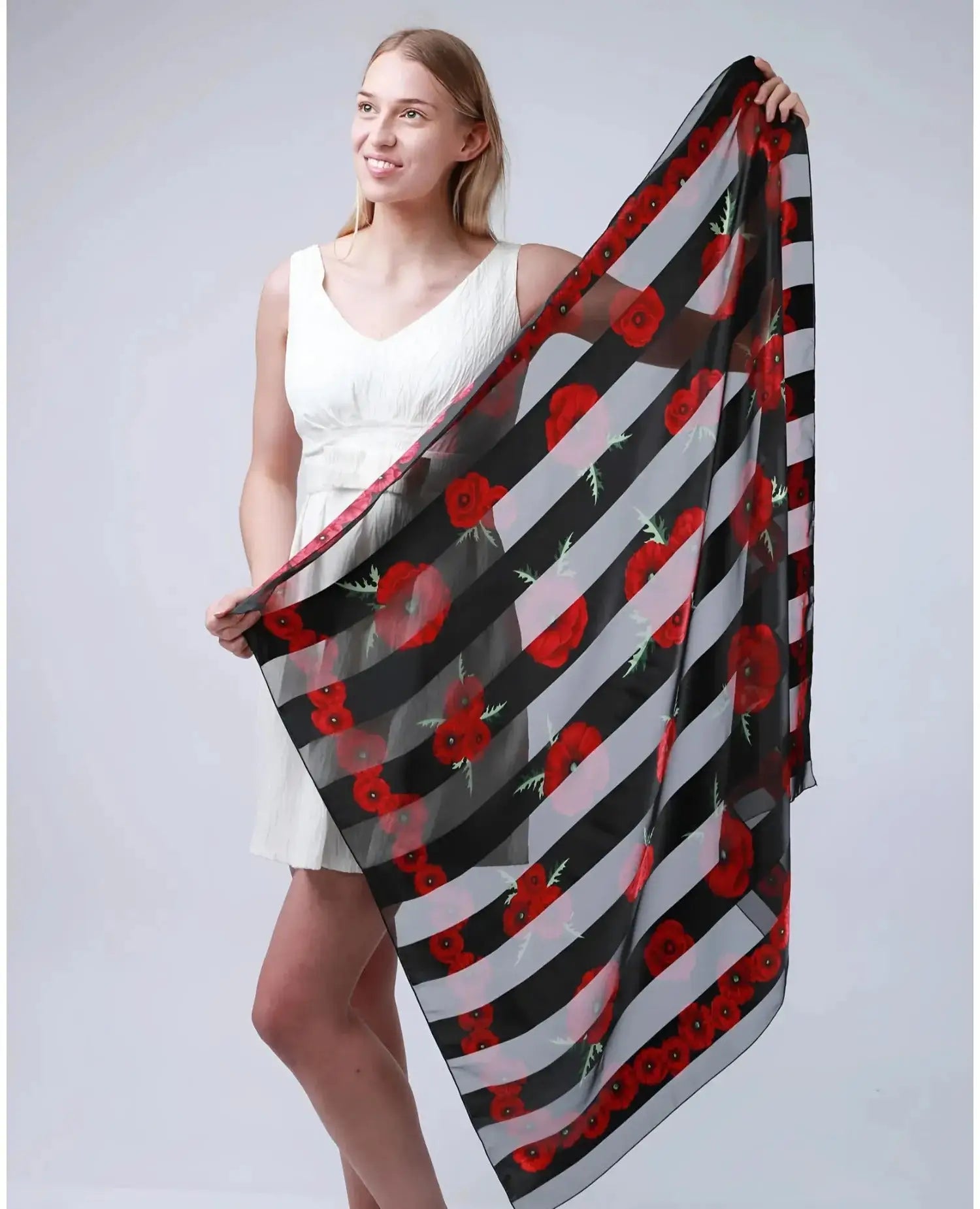 Woman wearing a black and white striped scarf with red flowers, Poppy Square Scarf & Holder Set for Remembrance Day.