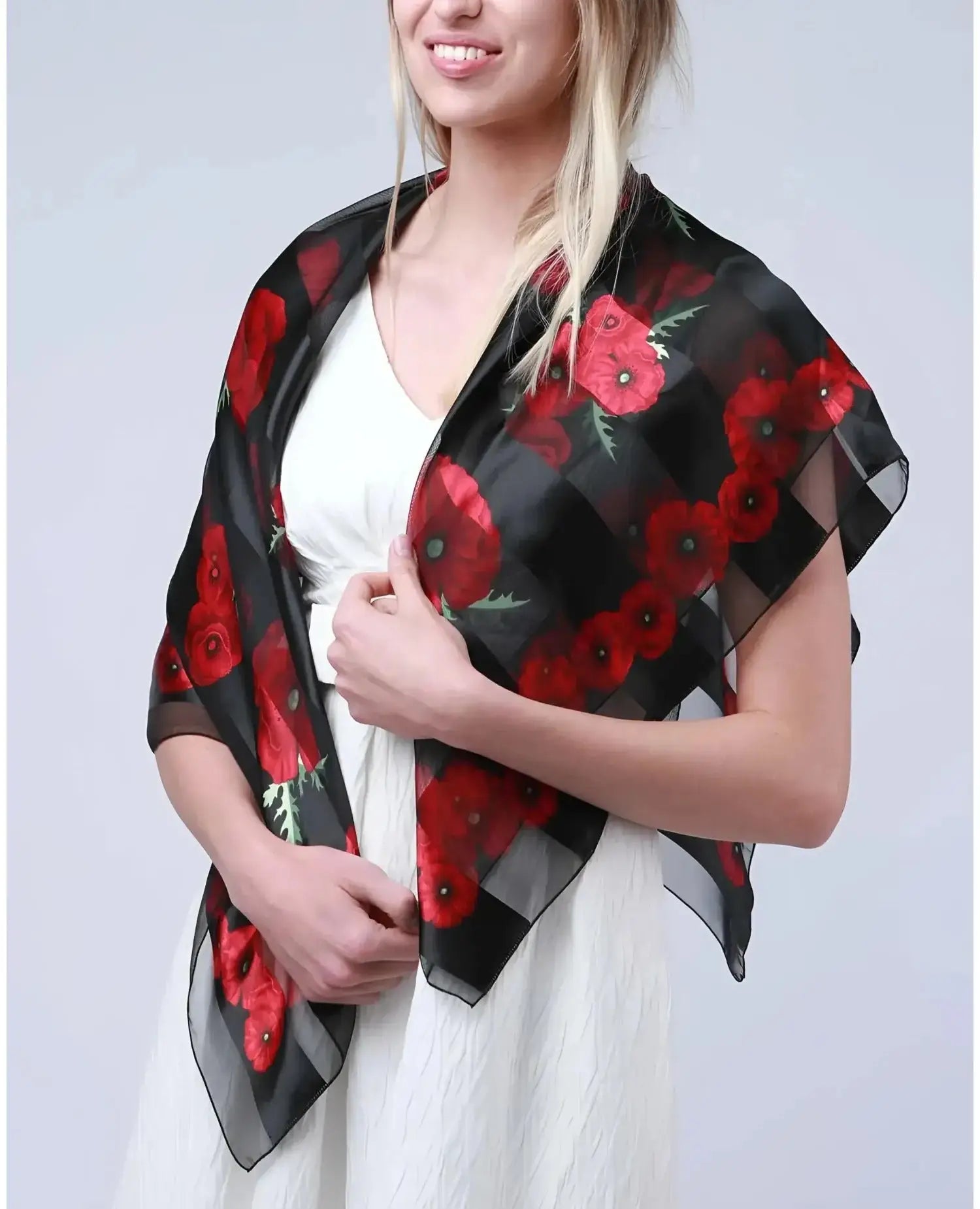 Woman wearing large square poppy scarf for Remembrance Day