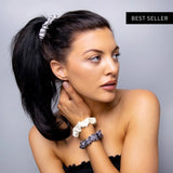 Woman wearing mulberry silk hair scrunchies with flower in hair.