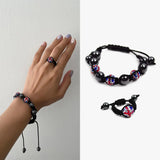 Woman’s hand holding Union Jack Shamballa Beaded Bracelet Ring Set