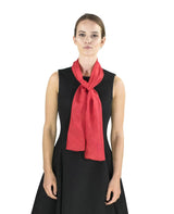 Woman in black dress and red scarf wearing 100% Mulberry Silk Luxurious Multiuse Scarf.