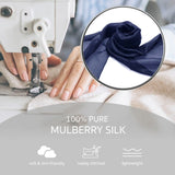 Woman sewing blue mulberry silk scarf with sewing machine, mulberry silk luxurious multiuse scarf.