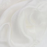 100% Mulberry Silk Luxurious Multiuse Scarf on white fabric background.