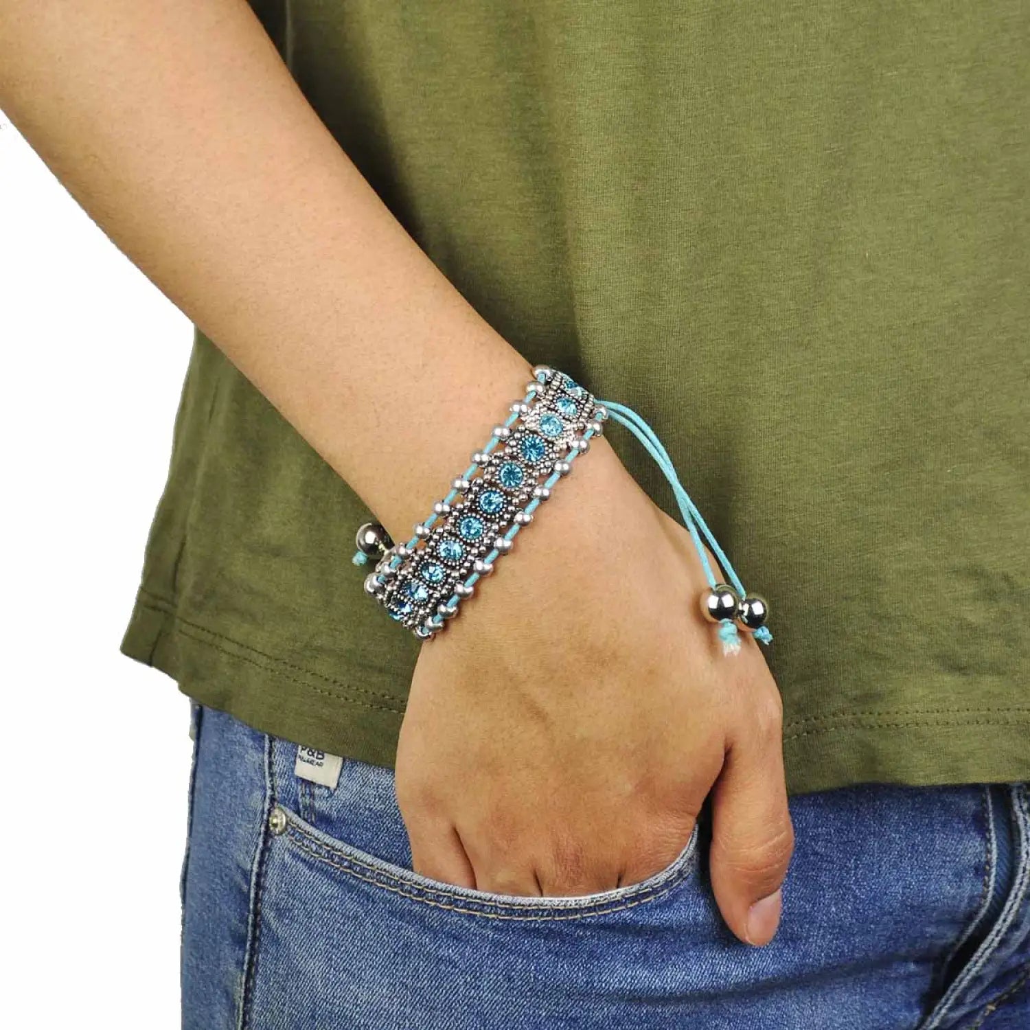 Woman wearing boho rhinestone elastic bead bracelets with blue beads.