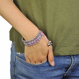 Boho rhinestone sterling elastic bead bracelet with pink beads worn by a woman