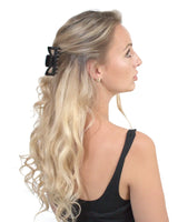 Blonde woman wearing black bow in Essential Hair Claw Clips Set