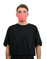 Stylish man wearing copper-infused face mask with red nose for protection.