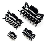 Essential Hair Claw Clips Set - Three black hair clips on white surface