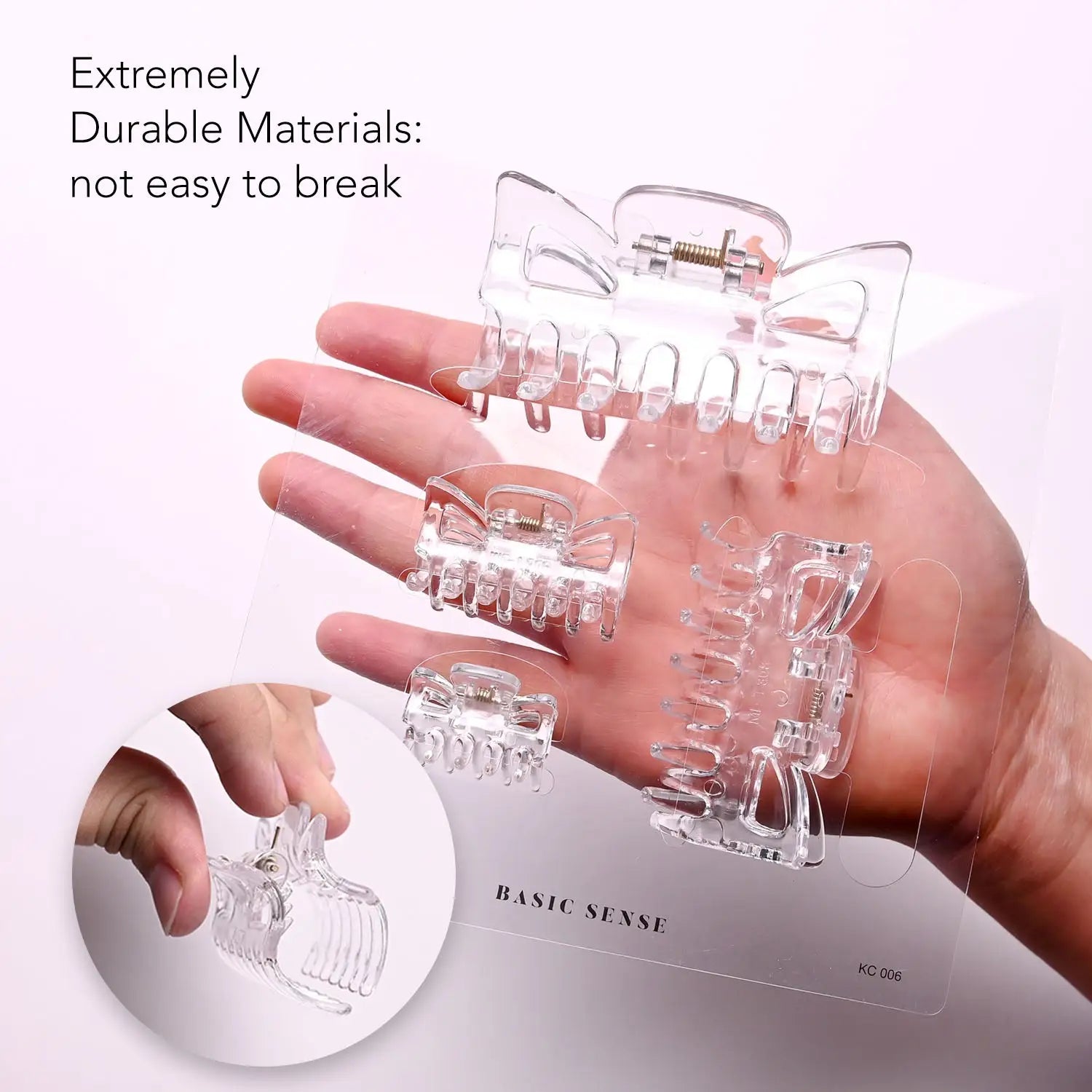 Essential hair claw clips set, hand holding clear box with glass - product display.