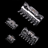 Set of four essential hair claw clips in various sizes displayed in clear glass wine glasses