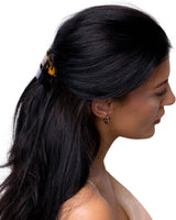 Woman wearing yellow flower hair clip from 4-Piece Hair Clip Set