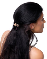 Woman with long black hair wearing leopard print hair clip from 4-Piece Hair Clip Set.