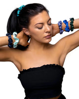 Woman wearing black top and blue bracelet using skinny small satin hair tie scrunchies