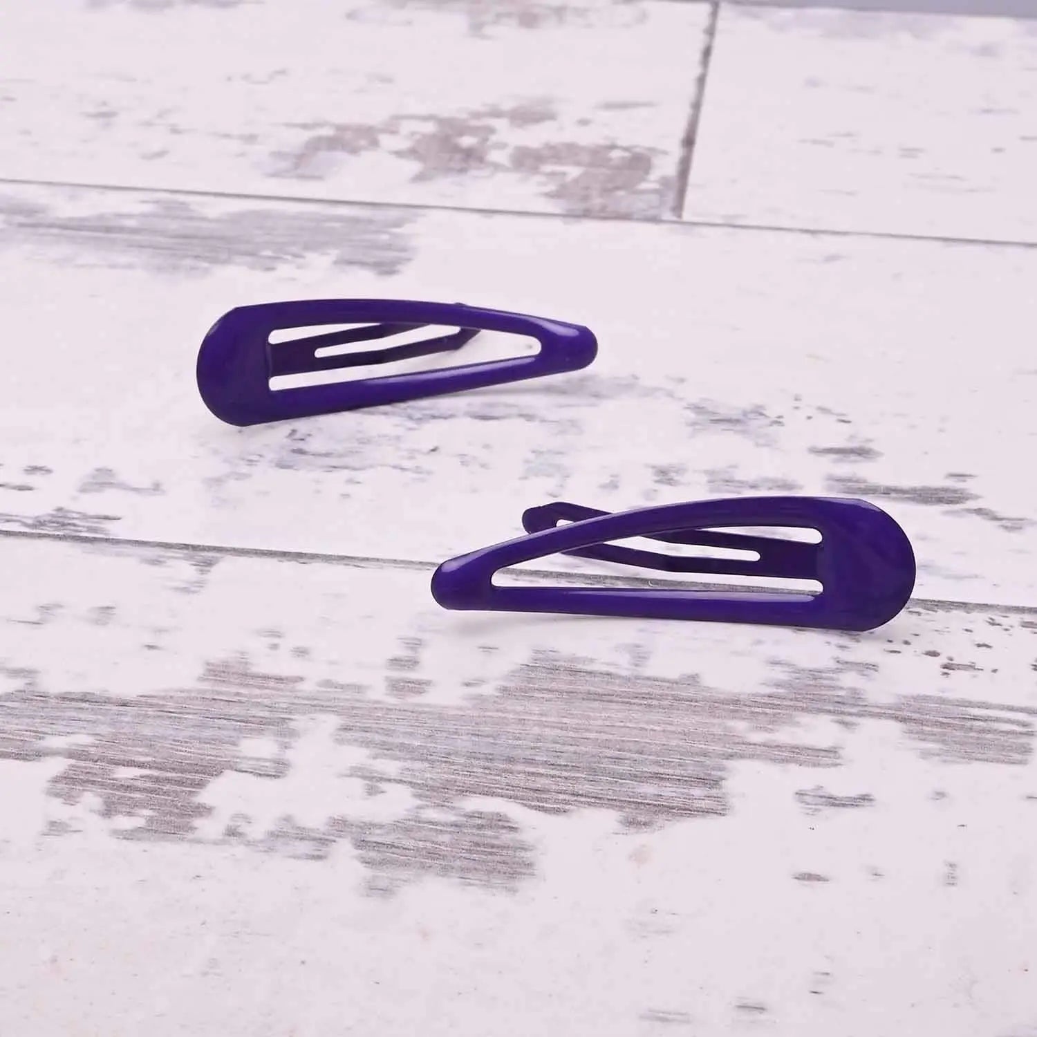 Two purple epoxy metal hair clips on white wooden floor - School-Ready Durable Hairpins