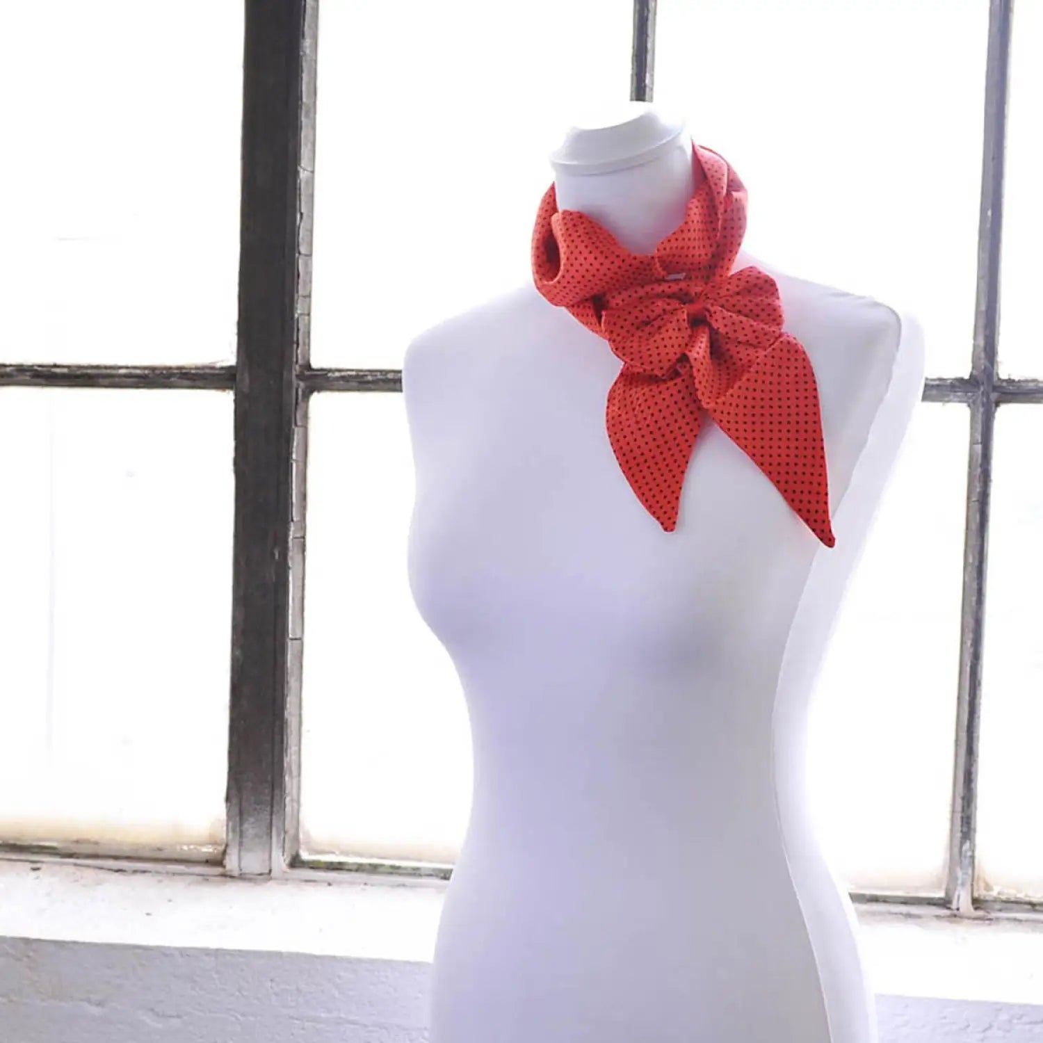 Red and black polka dot sash scarf on mannequin with matching hair pin set.