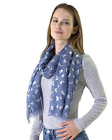 Woman wearing blue butterfly print silver foil oversized scarf