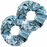 A close-up of a tie dye ombre grey hair scrunchie for women in daily use with black plain casual outfit