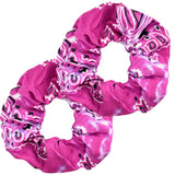 Single raspberry paisley scrunchie with distinct white patterns on a light surface
