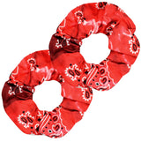 A close-up of a red scrunchie with two tone colour paisley patterns for classic women hair accessories