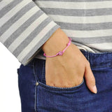 Diamante ball friendship bracelet with heart charm worn by woman.