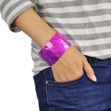 Woman wearing purple adjustable shell bar wristband.