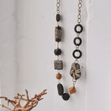 Art Patterned Wooden Beads Long Necklace hanging on wall