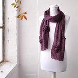 Shimmering knitted flower scarf on mannequin