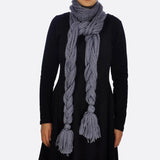 Stylish woman wearing oversized long plait knitted scarf