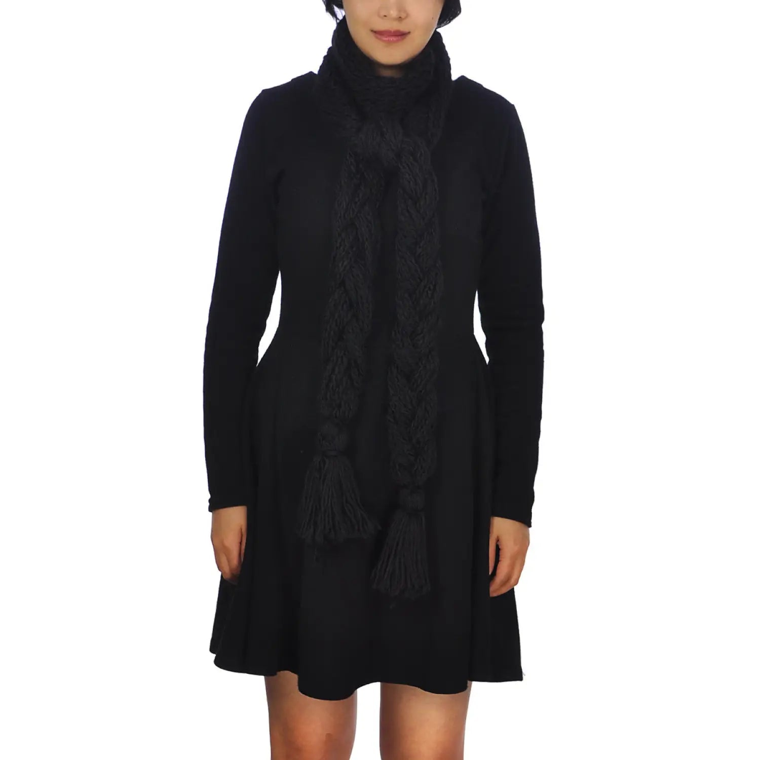 woman in black dress and scarf showcasing oversized long plait knitted scarf