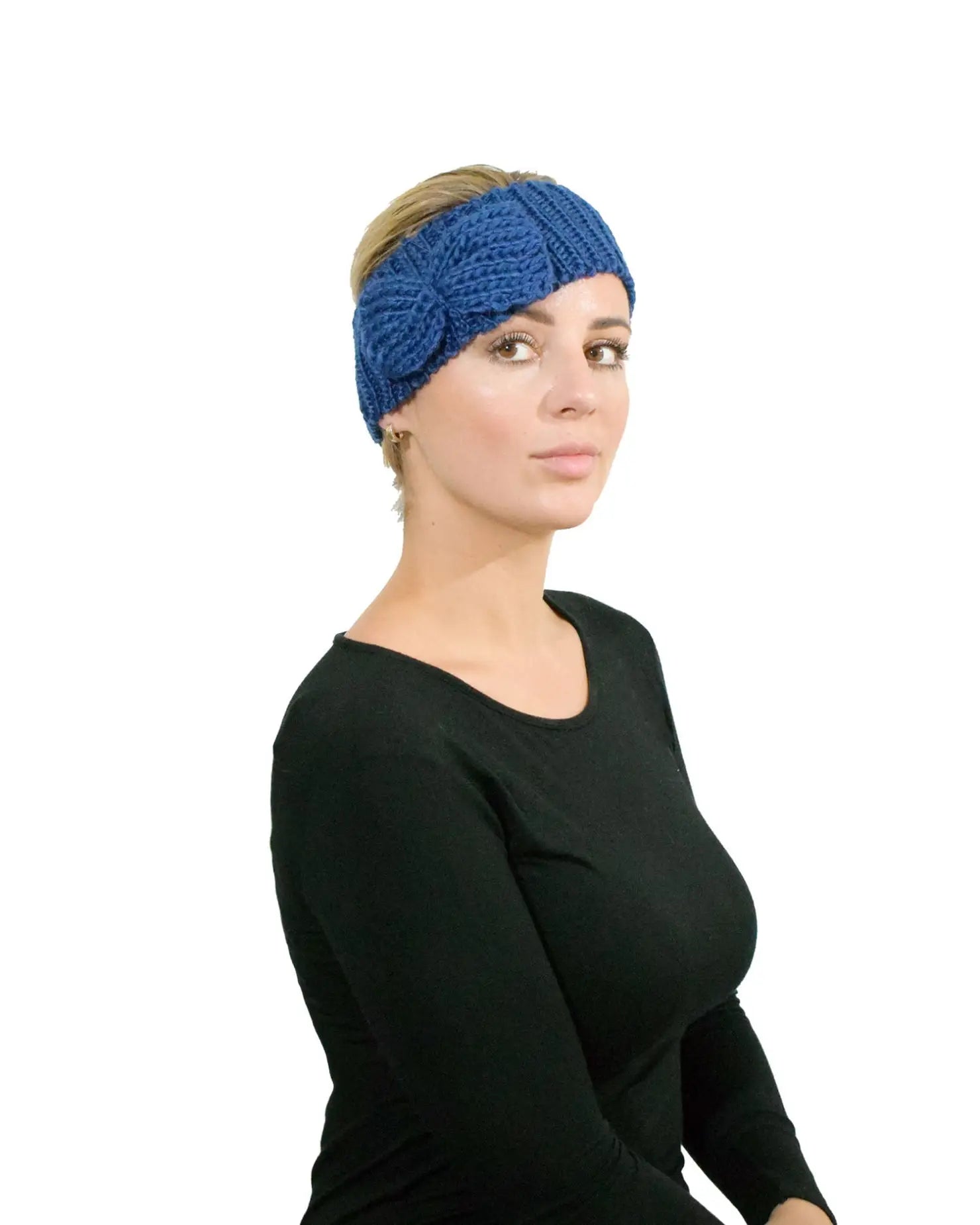 Woman wearing a blue bow-detailed knitted headband for autumn & winter