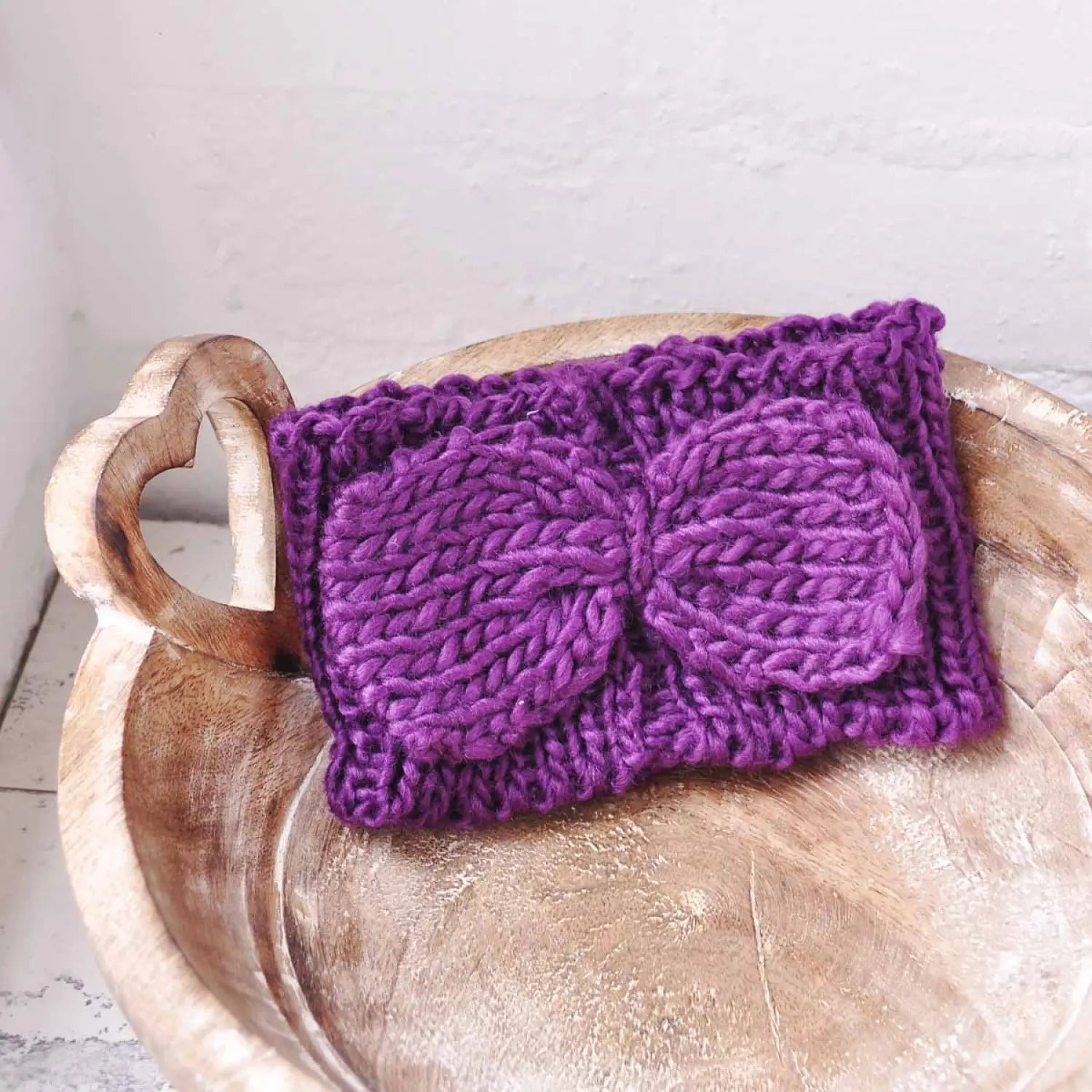 Purple knitted headband with bow detail for autumn & winter fashion.