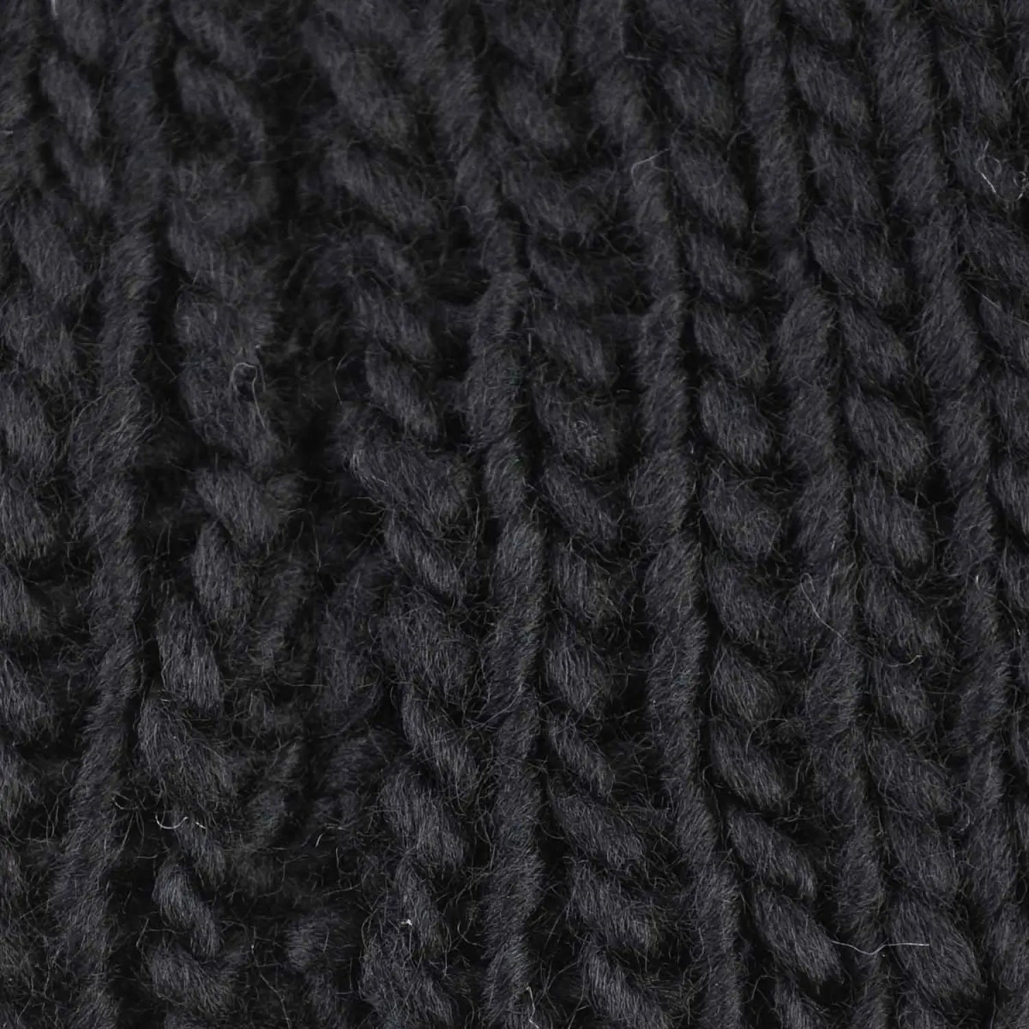 Black wool yarn close up on bow detailed knitted headband