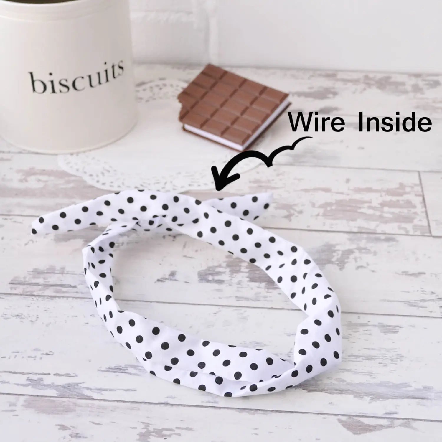 White and black polka dot headband with bunny ears referenced as retro polka dot wire headband