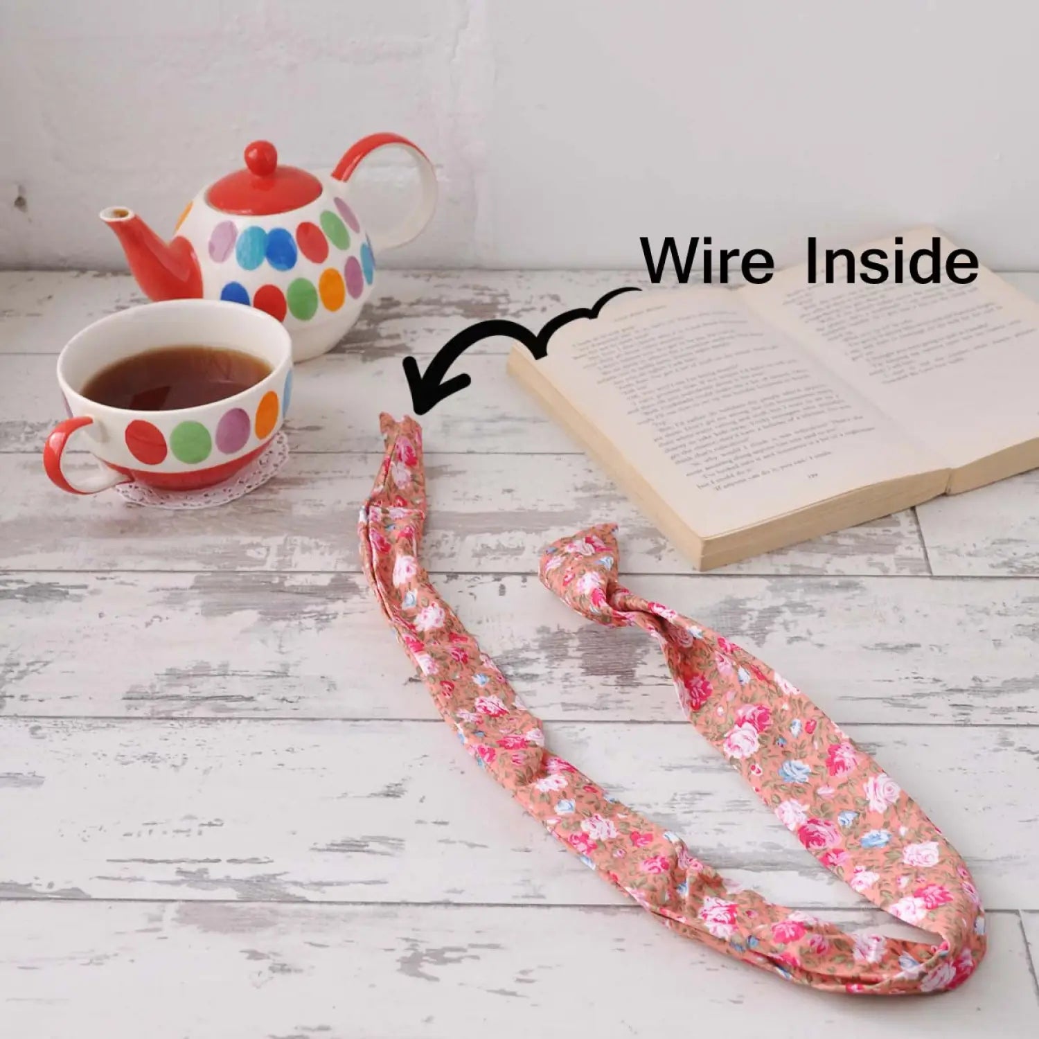Bunny Ears Retro Rose Print Wire Headband with book, cup, and teapot on table