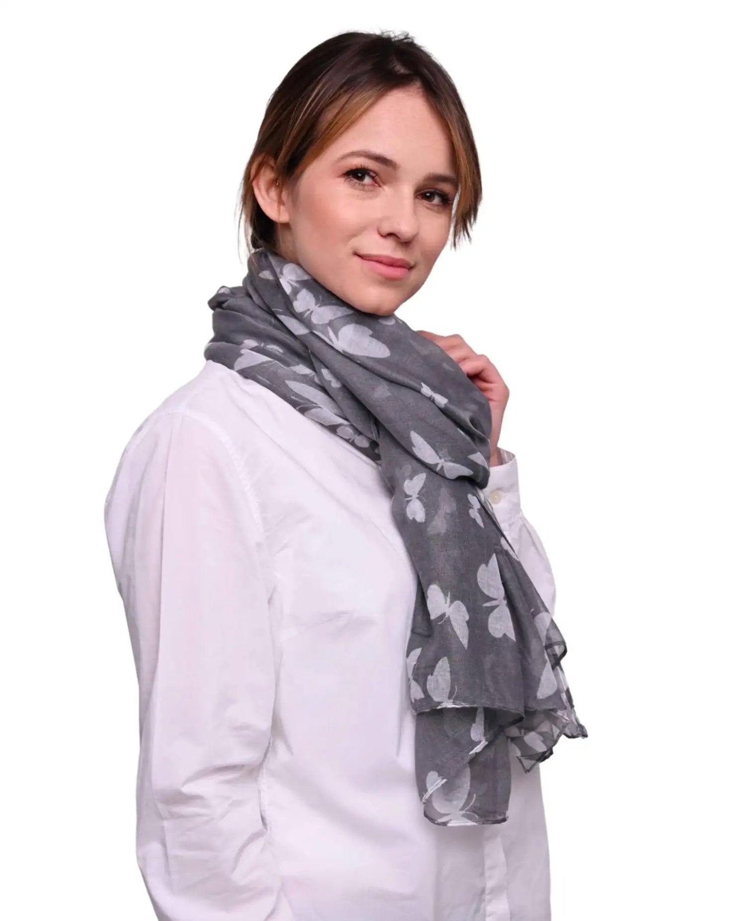 Woman wearing butterfly print oversized shawl.