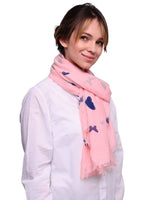 Woman wearing pink butterfly print oversized shawl with blue hearts