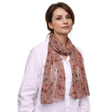 Floral patterned Butterfly Print Scarf in muted pink tones draped around a person’s neck