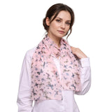 Woman in white top wearing lightweight butterfly print scarf with colorful butterflies