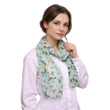 Light blue butterfly print scarf with pastel accents, a versatile accessory for any occasion