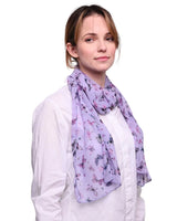 Woman wearing purple butterfly print scarf