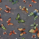 Grey background with vibrant butterfly print scarf, versatile accessory for every occasion.