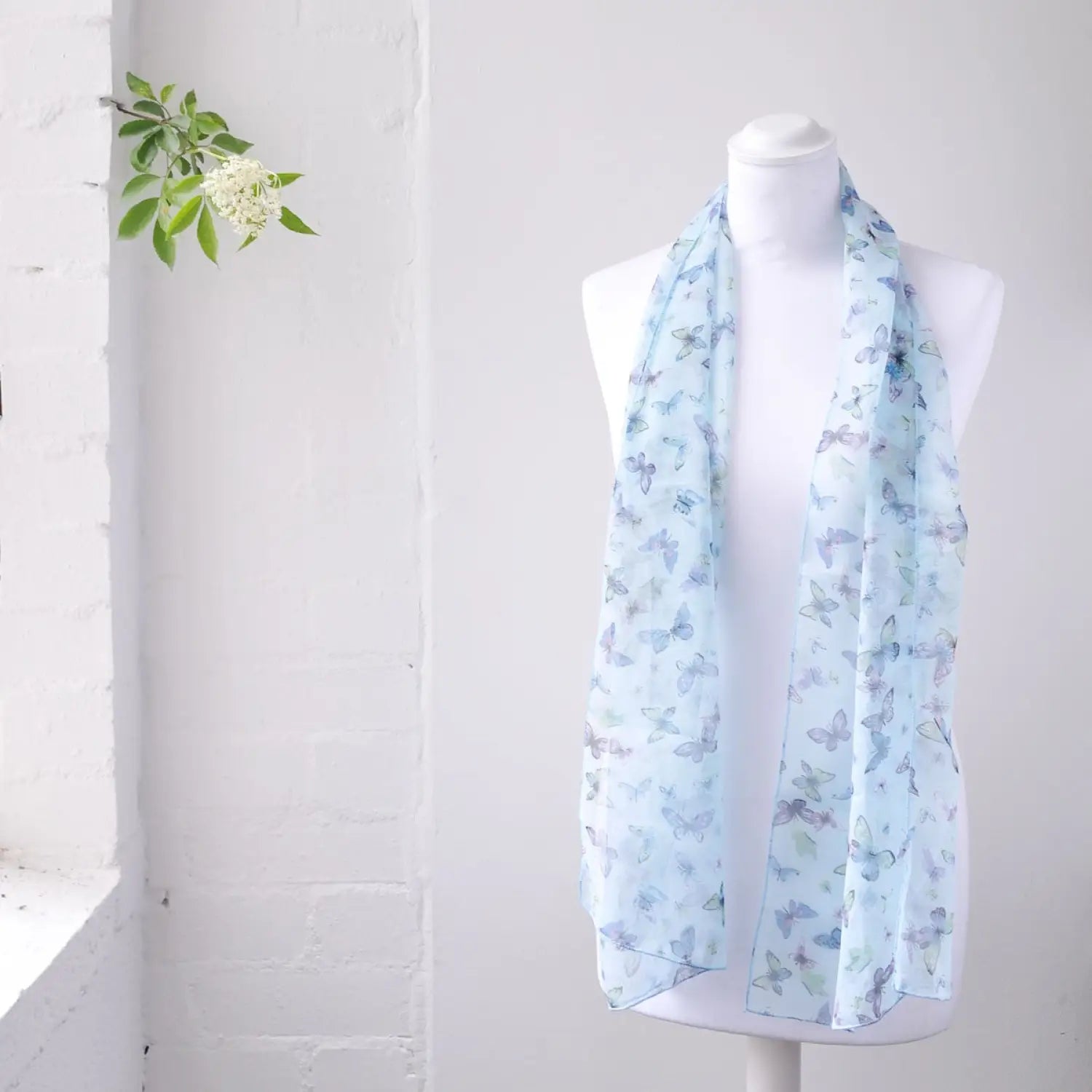 Light blue butterfly print scarf with floral pattern