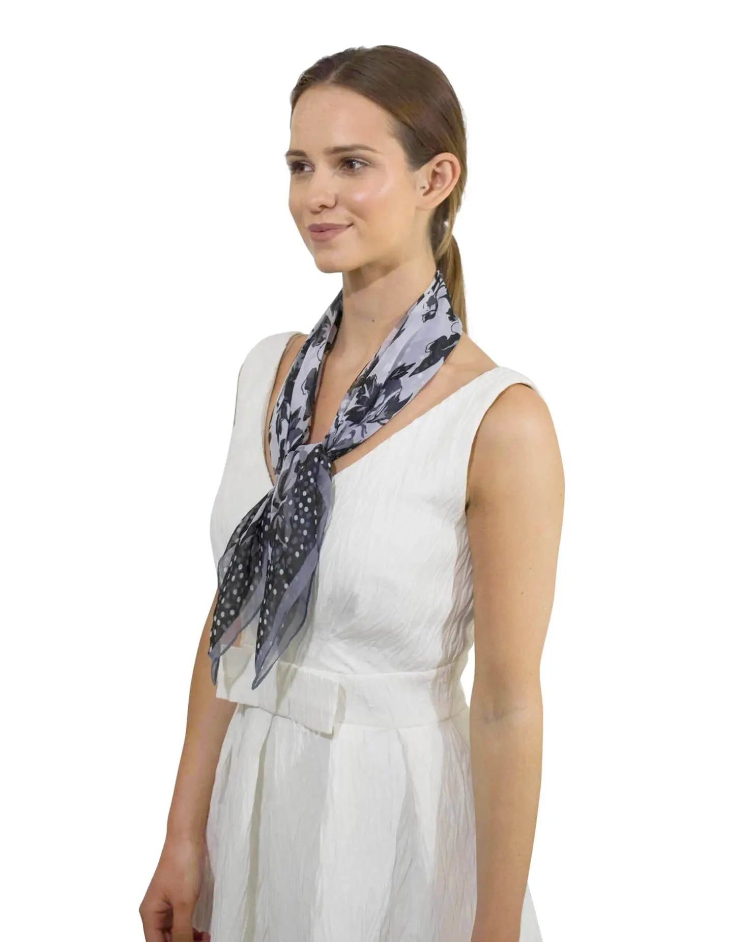 Woman wearing a white dress and blue scarf, showcasing Charming Polka Dot & Floral Small Square Scarf.